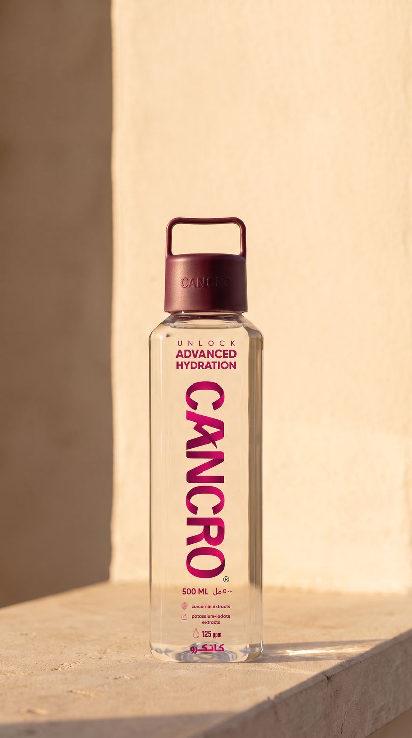 A Cancro bottle in late-afternoon sun on a travertine ledge